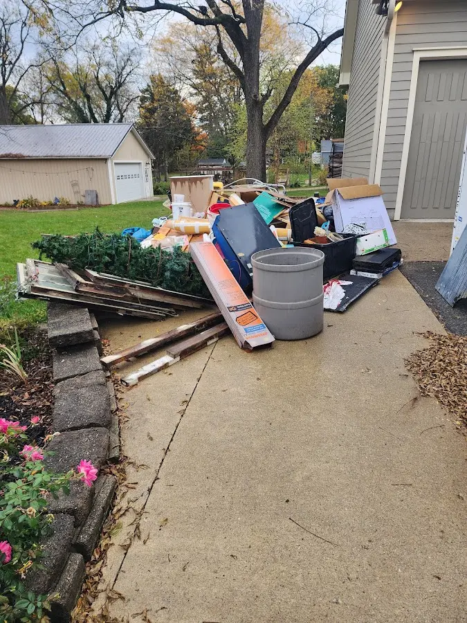 Dumpster being loaded with debris for Roofing Dumpster Rental in Concordia